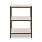 Nightstand styled as bedside table with lamp and books in warm bedroom environment