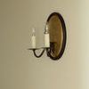 Distant angled view of Ancram Small Double Sconce mounted on plain beige wall with both bulbs lit