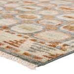 Close-up angled view showing rug pile texture and fringed edge with multicolor medallions