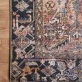 Detailed corner of Jules rug on wood floor emphasizing color contrast and woven textile texture