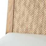 Close-up of woven herringbone pattern on teak chair back and white cushion edge