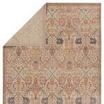 3x10 rug folded at corner to show reverse side with muted trellis pattern in cream and rust shades