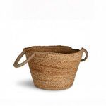 Side angle showing braided texture and curved handle wrapping on bamboo basket