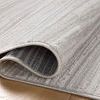 Close-up of rug edge slightly curled, displaying fabric texture and weave pattern