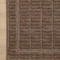 Corner close-up showing the tight weave and border design of the cocoa two-toned patterned rug