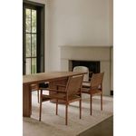 Two Remy Dining Chairs arranged with a wood dining table in a bright room with large windows.