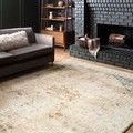 Rosette Clay / Ivory Rug displayed in living room setting near sofa and fireplace