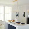 Boulevardier Bar Cart in a bright kitchen with large windows and a white island table with blue recessed panel