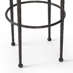 Close-up of hammered bronze circular footrest and ball-shaped feet on Corinne Stool