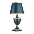 Travelogue lamp slightly angled left with scalloped navy shade and gold interior
