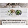 Overhead view of Tybee Table set with bowls of lime, bottle, glasses, and surrounded by cushioned chairs