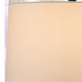 Close-up of beige fabric lampshade texture and green finial on top of the lamp