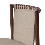 Close-up of left side upper backrest showing beige fabric and leather strap binding on dark wooden frame