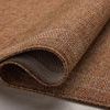 Side view of folded rug revealing the thickness and tight polypropylene weave