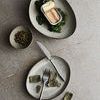 Styled overhead scene with Mame Dessert Plate holding seaweed and canned fish alongside another plate with cutlery