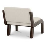 Back angled view of chair highlighting upholstery finish and block style wooden legs