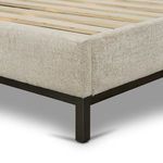 Close-up of metal bed frame corner joint supporting upholstered bed sides
