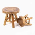 Two teak stools laying on side with one overturned to reveal bottom of thick wooden top