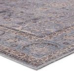 Close-up of textured corner showing detailed weave and muted blue and gray floral motif