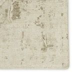 Close-up of rug surface highlighting faded medallion pattern and woven texture