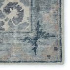 detailed close-up of vibrant blue corner edge with visible hand knotting and border pattern