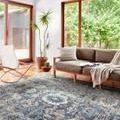 Samra Grey / Multi Rug styled in bright living room with modern furniture and large windows