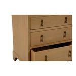 Close-up angled view focusing on chest’s drawer handles and wood texture
