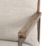 Detailed end view of wood armrest with metal support underneath