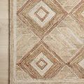 Close-up of Varena rug corner showing detailed diamond pattern and texture on wooden floor