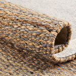 Rolled edge displaying thickness and handwoven jute and wool fiber details