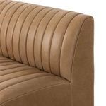 Close-up on banquette back corner with visible vertical channel stitching and leather grain texture