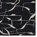 Detailed corner close-up showing intricate wool tufting and abstract lines in black and cream.