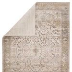 Back side of rug flipped over showing solid cream fiber backing on Tajsa Medallion rug