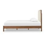 Close-up showing detailed soft weave texture of ivory performance fabric on headboard