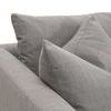 Close-up of two pillows resting against upholstered armrest of sofa