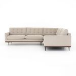 Side view of three-piece sectional showing wrap-around frame and mid-century cone legs