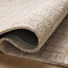 Close-up of the rug folded over showing thick wool texture and jute backing.