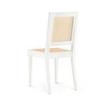 Rear angle showing gently curved back legs and cane back panel of the white side chair