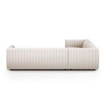 Opposite side view emphasizing the smooth vertical tufting and block shaped armrest