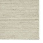 Close-up of rug surface showing horizontal weave pattern and subtle heathered color variation