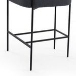 Rear view highlighting blocky boucle seat cushion and circular curved backrest
