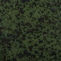 Extreme close-up of ceramic base splatter finish highlighting speckled moss green and black glazing
