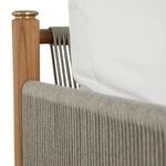 Close-up on braided rope texture meeting vertically joined teak frame post