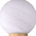 Close-up view focusing on the texture of white veined glass globe atop travertine column