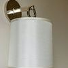 Close-up side angle of French Cuff Sconce highlighting silk shade weave and round backplate finish