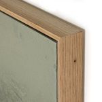 Close-up of corner of painting showing smooth canvas texture and light wood grain frame