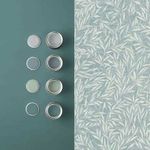 Salix Leaves wallpaper beside matching paint swatches on flat surface showing color coordination