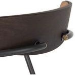 Close-up of dark wood curved back support with black metal bracket and brass accent bolt