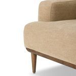 Close-up on tapered wood leg with metal foot cap against light background