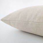 Close-up side view showing fine weave texture and seam detail of alabaster beige pillow cover